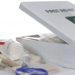 An open first aid kit with the content on the table