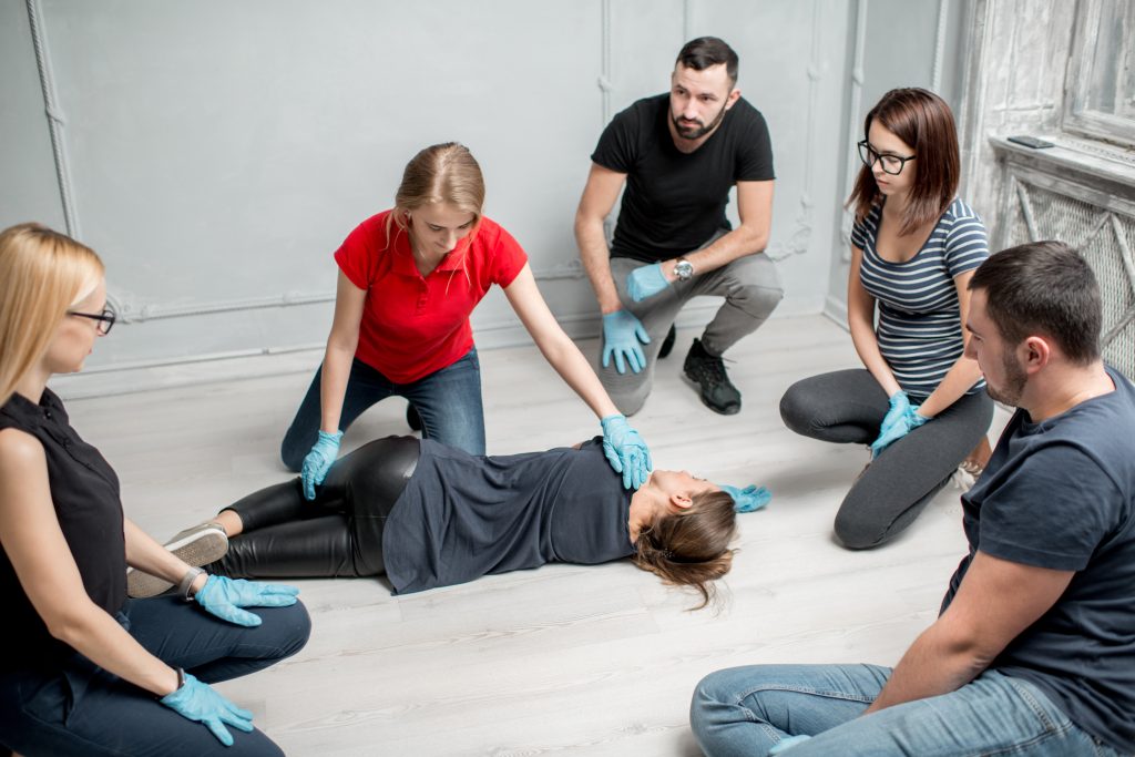 First Aid trainer demonstrating the recovery position
