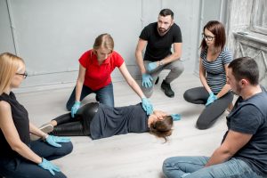 First Aid instructor teaching recovery position